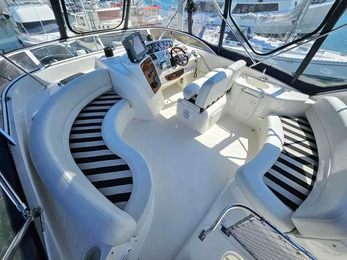  Yacht Photos Pics Luxurious 2007 Meridian 411 Sedan yacht interior with striped seating and modern helm.