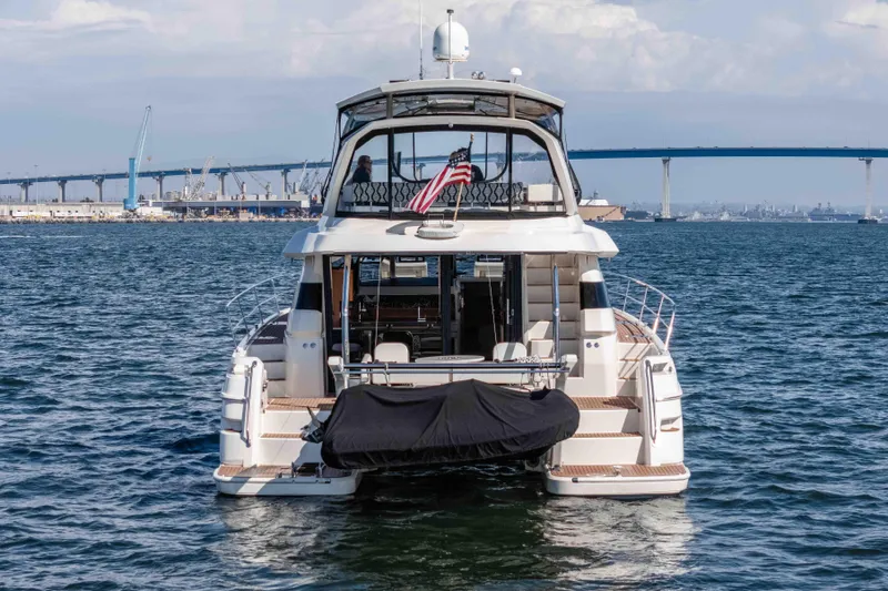 Catatude Yacht Photos Pics Aquila 44 Power Cat 2016 yacht on water, with bridge and cityscape in background.