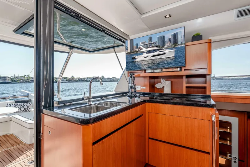 Catatude Yacht Photos Pics Luxurious interior of 2016 Aquila 44 Power Cat with modern kitchen and waterfront view.