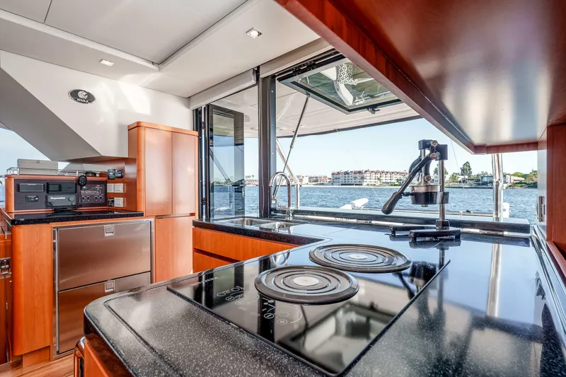 Catatude Yacht Photos Pics Luxurious kitchen interior of 2016 Aquila 44 Power Cat with waterfront view.
