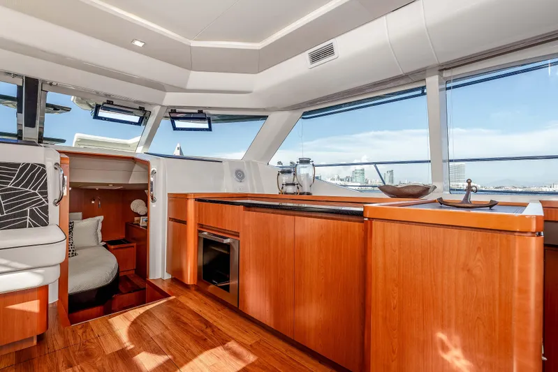 Catatude Yacht Photos Pics Luxurious interior of 2016 Aquila 44 Power Cat with modern kitchen and panoramic windows.