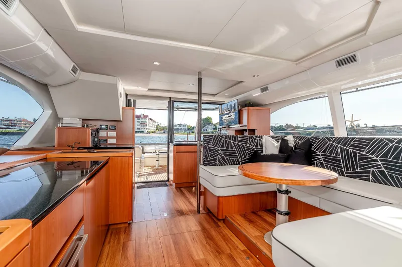 Catatude Yacht Photos Pics Luxurious interior of 2016 Aquila 44 Power Cat with modern seating and panoramic windows.