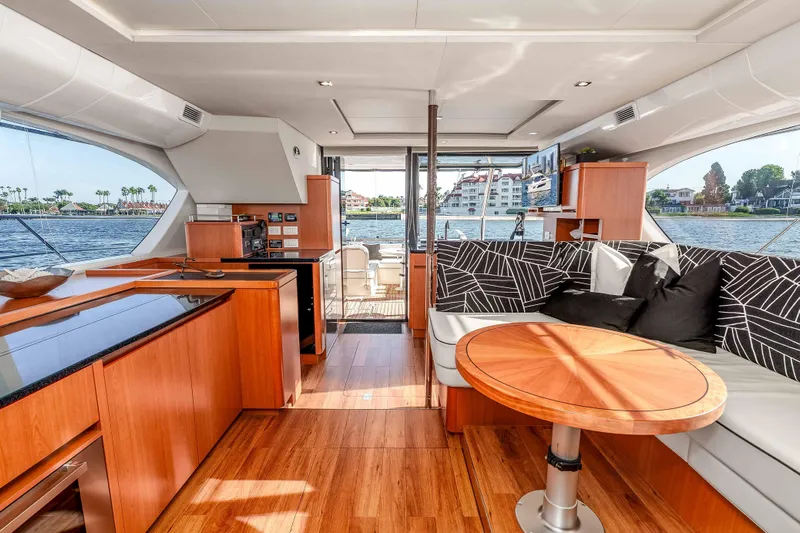 Catatude Yacht Photos Pics Luxurious interior of 2016 Aquila 44 Power Cat with modern wood finishes and scenic water views.