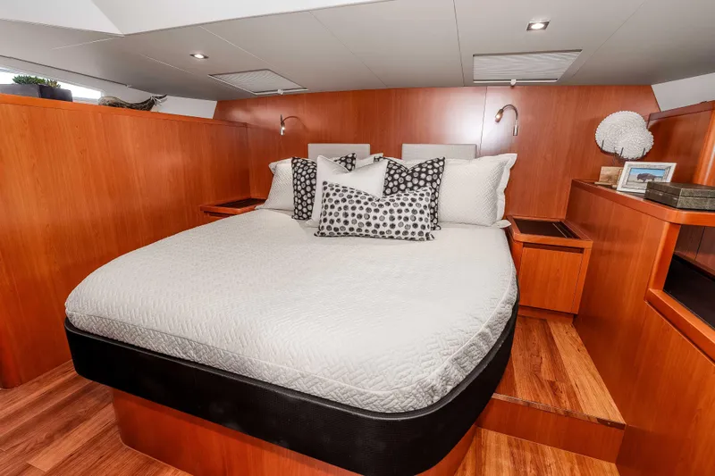 Catatude Yacht Photos Pics Luxurious bedroom interior of 2016 Aquila 44 Power Cat with modern wood finish.