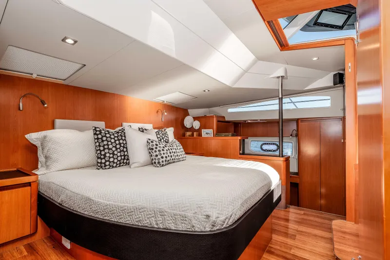Catatude Yacht Photos Pics Luxurious cabin interior of 2016 Aquila 44 Power Cat with elegant wood finish and skylight.