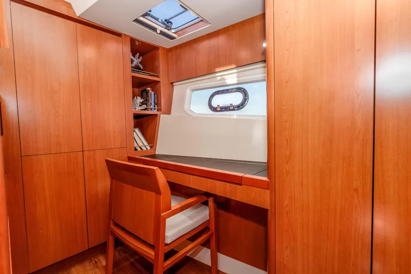 Catatude Yacht Photos Pics Luxurious wooden interior of 2016 Aquila 44 Power Cat with desk and chair.