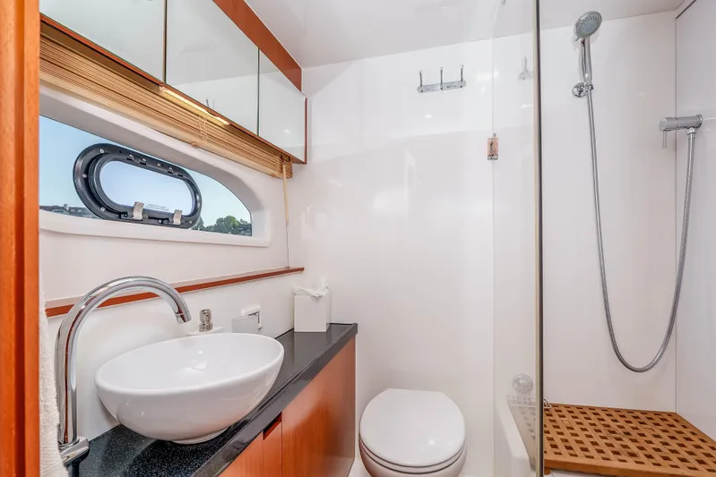 Catatude Yacht Photos Pics Luxurious bathroom on 2016 Aquila 44 Power Cat with modern fixtures and shower.