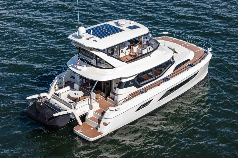 Catatude Yacht Photos Pics 2016 Aquila 44 Power Cat cruising on open water, showcasing sleek design and spacious deck.