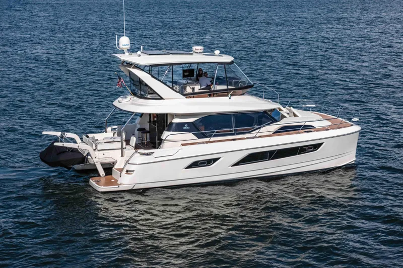 Catatude Yacht Photos Pics 2016 Aquila 44 Power Cat cruising on open water, showcasing sleek design and modern features.