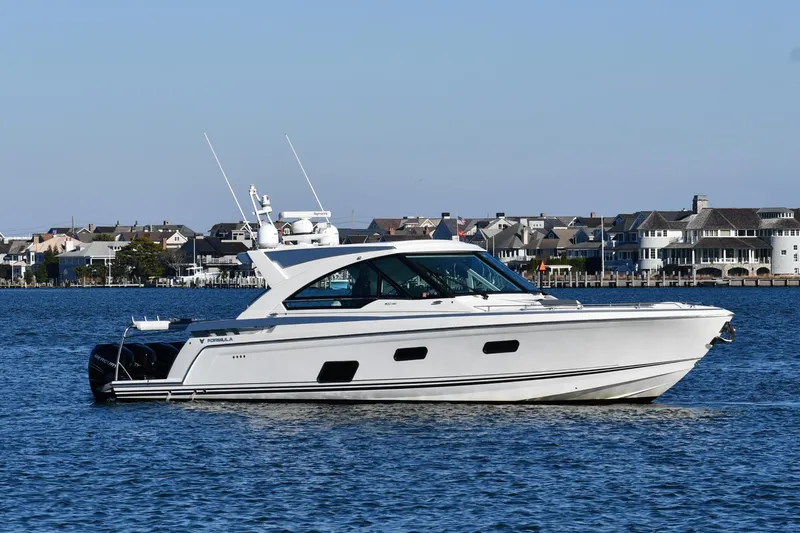  Yacht Photos Pics 2020 Formula 400 Super Sport Crossover yacht on calm water near coastal homes.