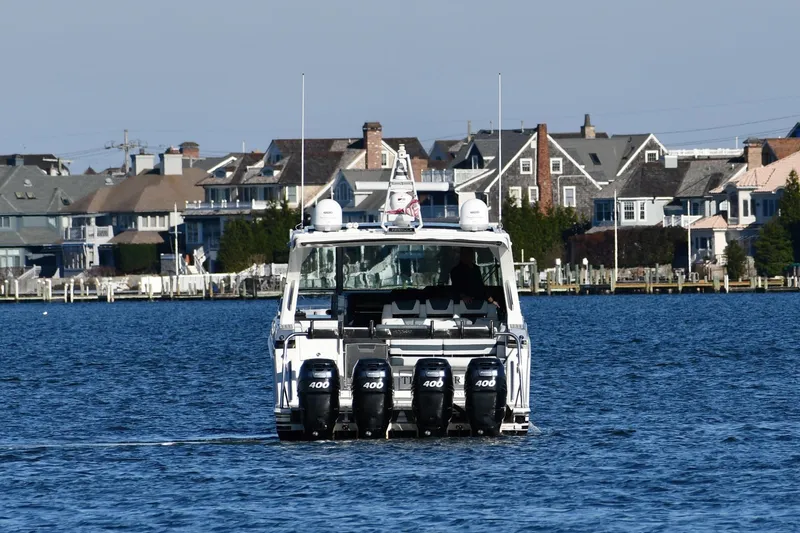  Yacht Photos Pics 2020 Formula 400 Super Sport Crossover boat cruising near waterfront homes.
