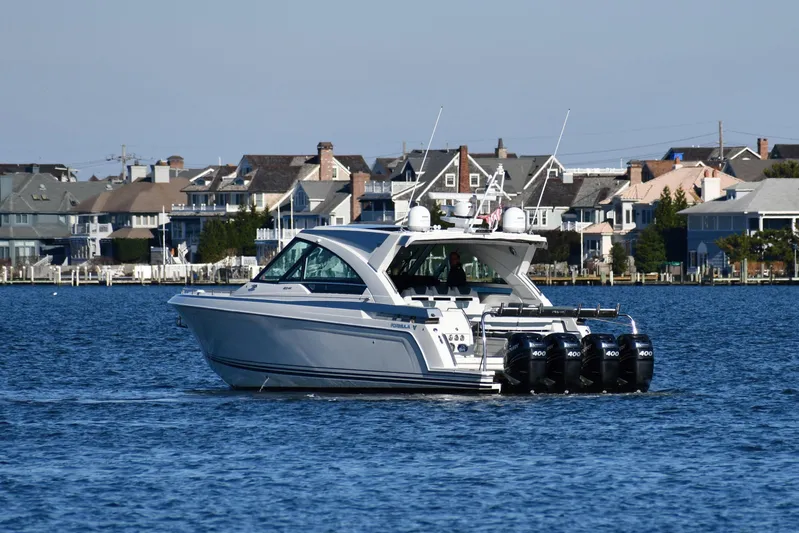  Yacht Photos Pics 2020 Formula 400 Super Sport Crossover boat cruising near waterfront homes.