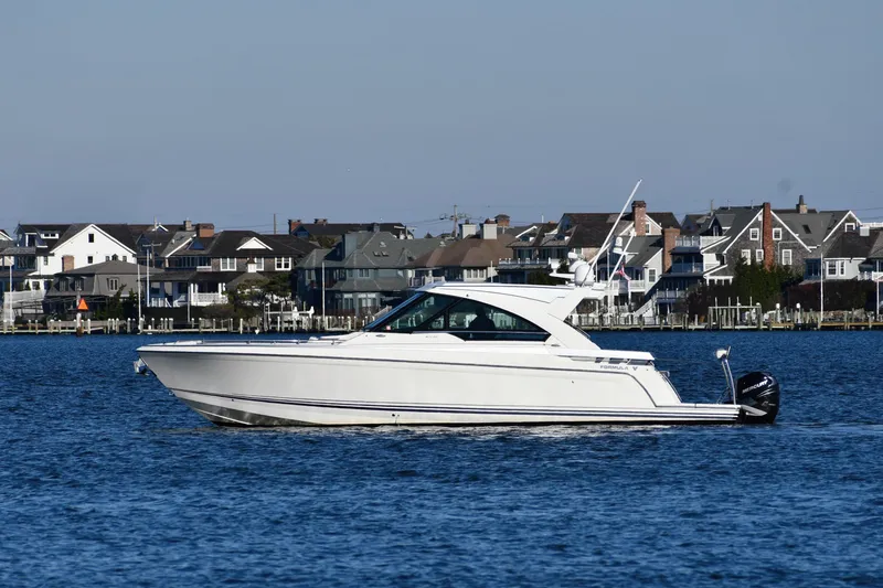  Yacht Photos Pics 2020 Formula 400 Super Sport Crossover boat cruising near coastal homes.