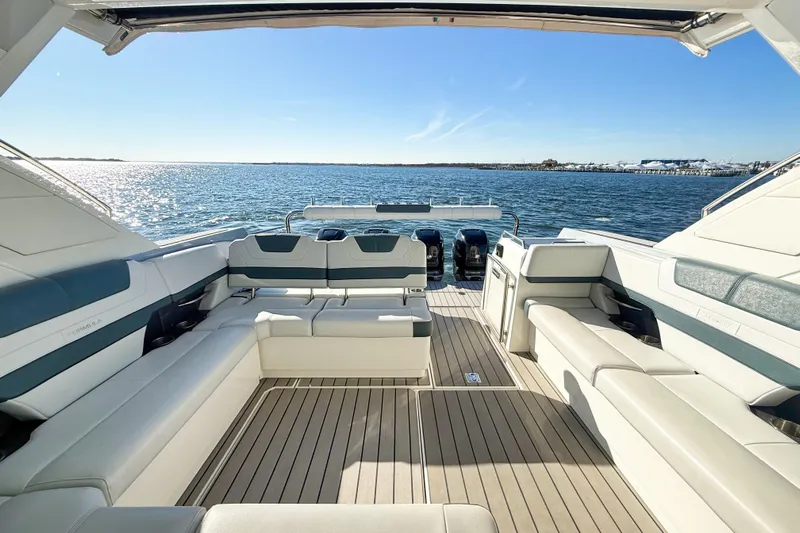  Yacht Photos Pics Luxurious 2020 Formula 400 Super Sport Crossover boat interior with spacious seating, overlooking serene waters.