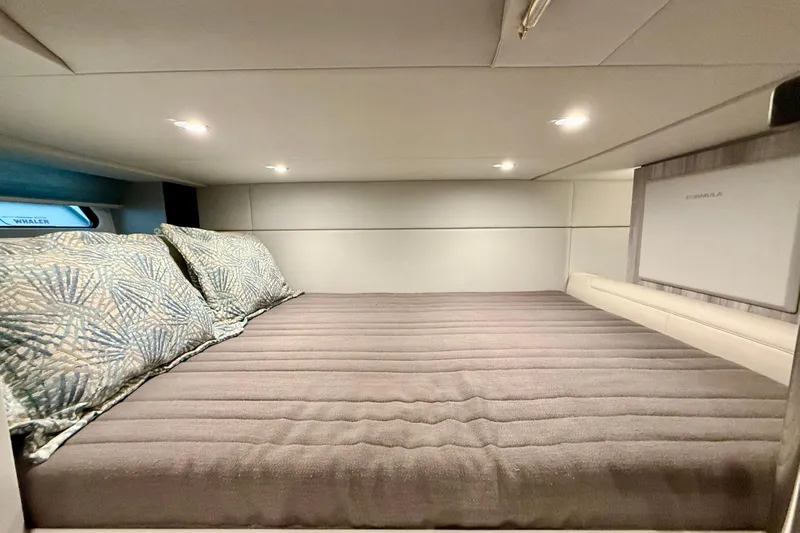  Yacht Photos Pics Cozy cabin interior of 2020 Formula 400 Super Sport Crossover with plush bedding.
