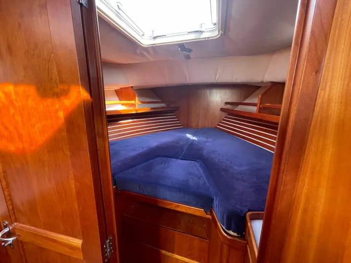  Yacht Photos Pics Interior cabin of 1997 Little Harbor WhisperJet 36 with blue bedding and wooden finish.