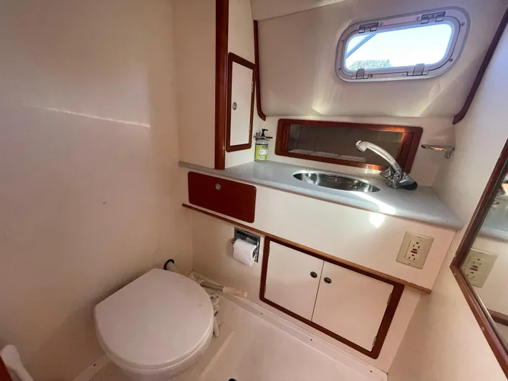  Yacht Photos Pics Bathroom interior of 1997 Little Harbor WhisperJet 36 yacht, featuring sink and toilet.