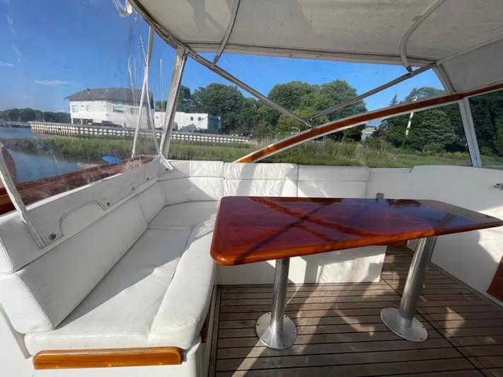  Yacht Photos Pics Interior of 1997 Little Harbor WhisperJet 36 with white seating and wooden table.