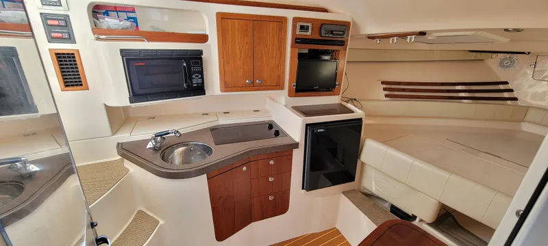 Fishin' Feinz Yacht Photos Pics 2008 Grady-White 330 Express cabin interior with kitchenette and seating area.