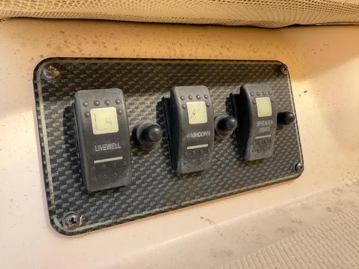 Fishin' Feinz Yacht Photos Pics Control panel on a 2008 Grady-White 330 Express boat with switches for livewell, washdown, and spreader lights.