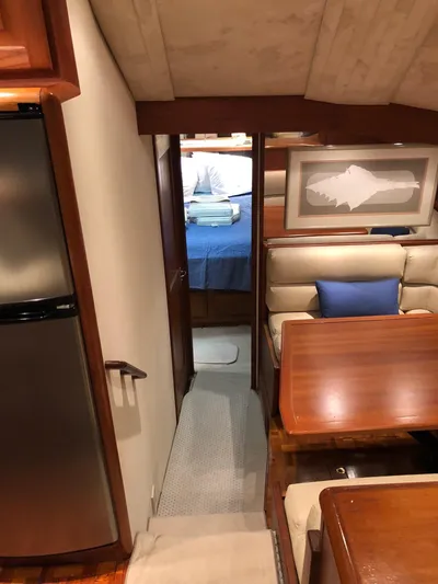 Pigal Yacht Photos Pics Interior of a 1990 Viking 38 Convertible yacht with dining area and bedroom.