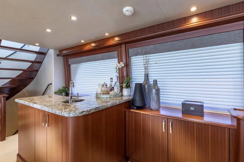  Yacht Photos Pics Luxurious interior of 2014 Pacific Mariner 85 Motor Yacht with elegant wood finishes and granite countertop.