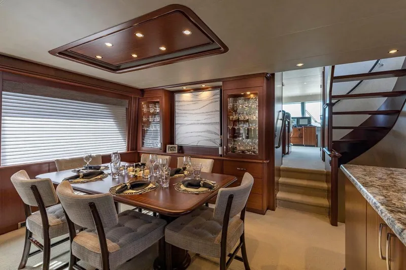  Yacht Photos Pics Luxurious dining area in 2014 Pacific Mariner 85 Motor Yacht, featuring elegant table settings and wood finishes.