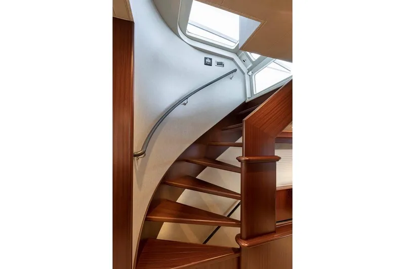  Yacht Photos Pics Elegant wooden staircase inside 2014 Pacific Mariner 85 Motor Yacht, featuring sleek design and skylight.