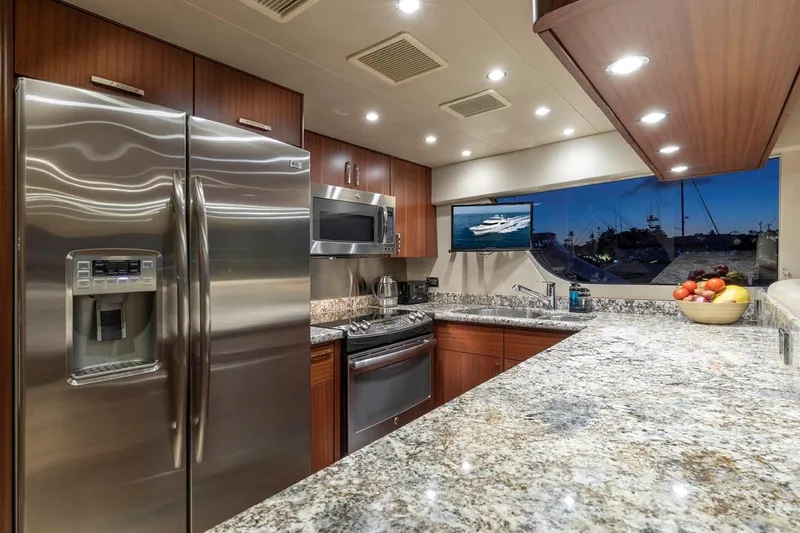  Yacht Photos Pics Luxurious kitchen in 2014 Pacific Mariner 85 Motor Yacht with modern appliances and granite countertops.