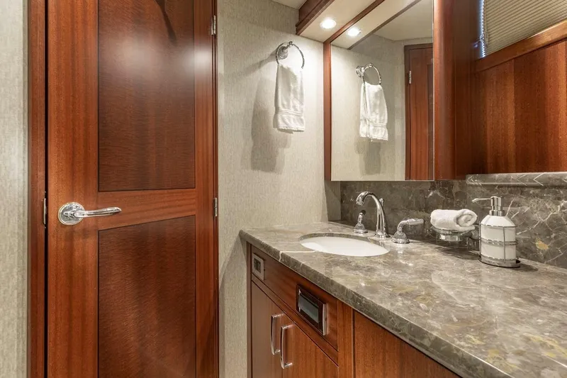  Yacht Photos Pics Luxurious bathroom in 2014 Pacific Mariner 85 Motor Yacht with marble countertop and wooden accents.