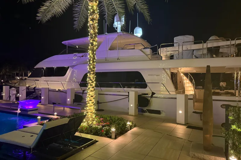  Yacht Photos Pics Luxurious 2014 Pacific Mariner 85 Motor Yacht docked at night, illuminated by elegant lighting.