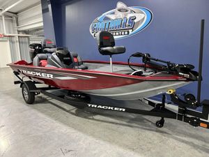 2025 Tracker Pro Team 175 Tournament Edition boat in showroom, red and gray design.