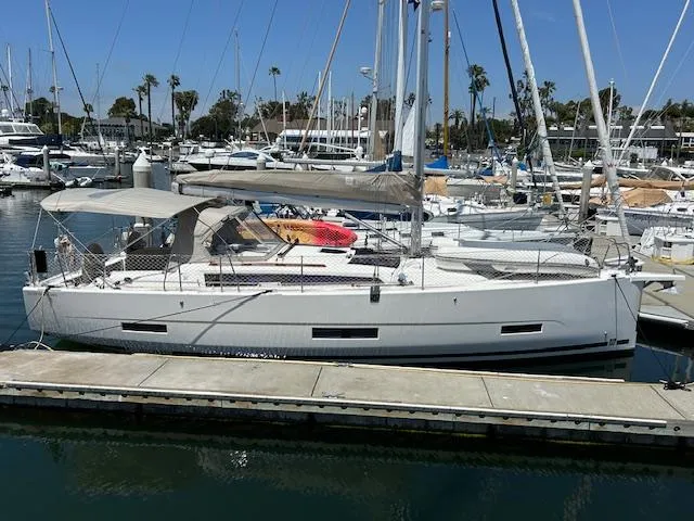 Gem Yacht Photos Pics 2022 Dufour 390 sailboat docked at a marina.