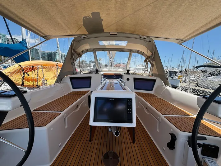 Gem Yacht Photos Pics 2022 Dufour 390 yacht cockpit with modern navigation systems and teak flooring.