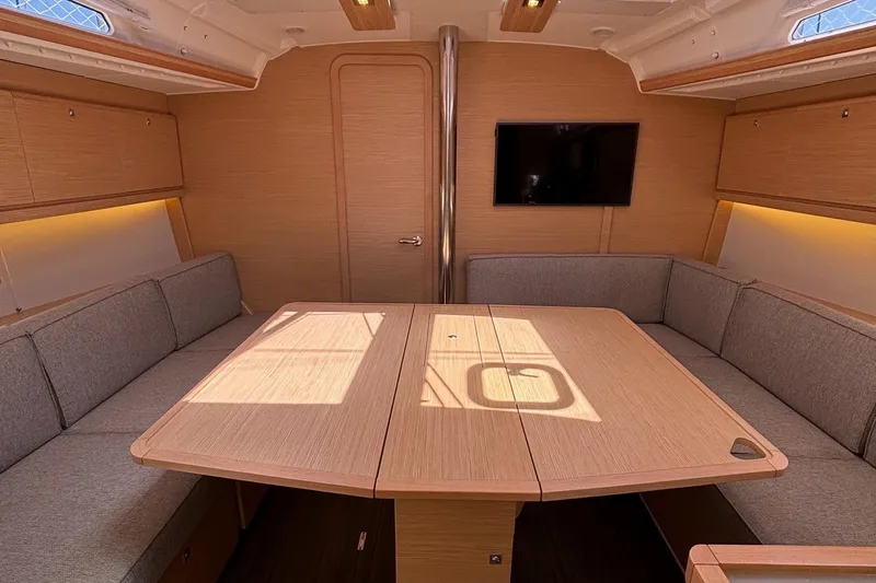 Gem Yacht Photos Pics Modern interior of 2022 Dufour 390 sailboat with spacious seating and dining area.