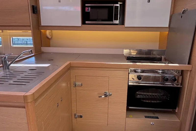 Gem Yacht Photos Pics Modern kitchen in 2022 Dufour 390 yacht with oven, microwave, and sink.