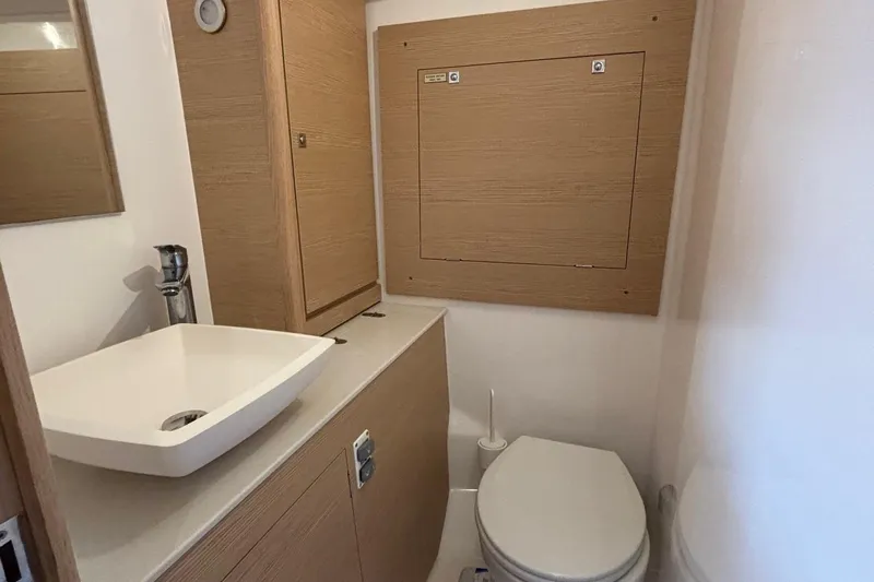 Gem Yacht Photos Pics Modern bathroom in 2022 Dufour 390 yacht with sink and toilet.