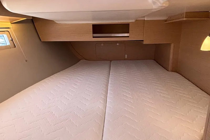 Gem Yacht Photos Pics 2022 Dufour 390 yacht cabin with twin beds and wooden interior.