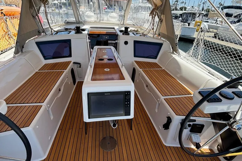 Gem Yacht Photos Pics 2022 Dufour 390 yacht cockpit with teak flooring and navigation equipment.