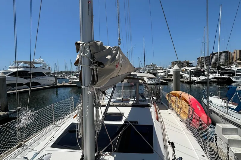 Gem Yacht Photos Pics 2022 Dufour 390 sailboat docked at a marina with kayaks on deck.