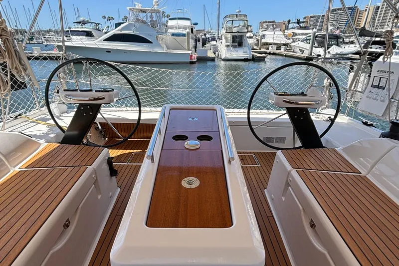 Gem Yacht Photos Pics Dufour 390 2022 sailboat cockpit with dual steering wheels in a marina.