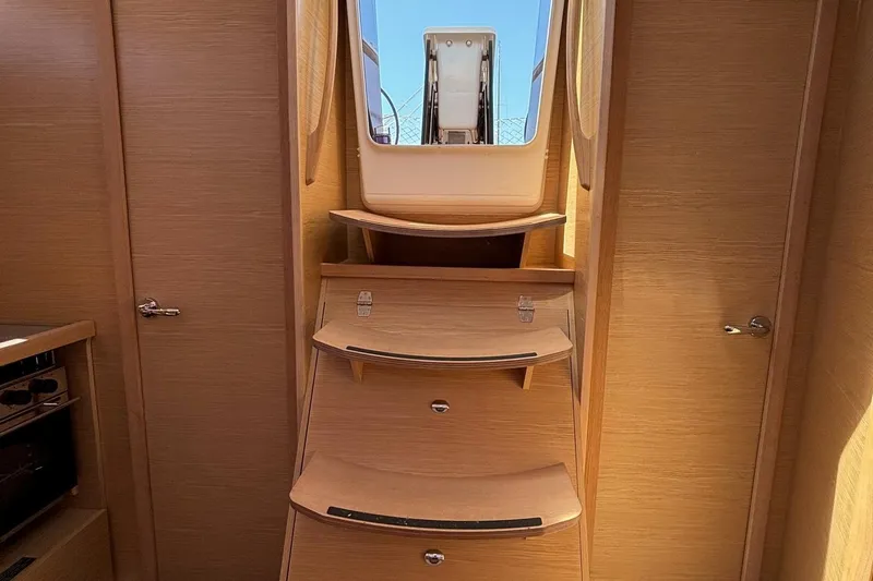Gem Yacht Photos Pics Interior stairs of 2022 Dufour 390 sailboat with wooden finish.