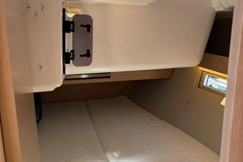Gem Yacht Photos Pics Cozy cabin interior of 2022 Dufour 390 sailboat with a comfortable bed.