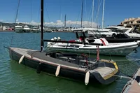 2023 Tofinou 9.7 sailboat docked in a marina, surrounded by other boats.