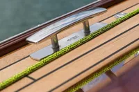 Close-up of 2023 Tofinou 9.7 yacht deck with cleat and green rope.