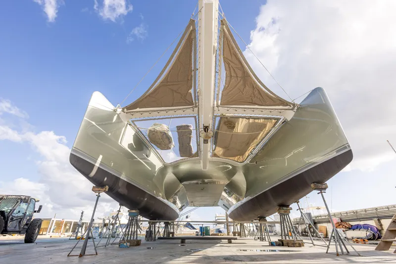  Yacht Photos Pics Catamaran Tag 60, 2018 model, on dry dock with clear sky background.