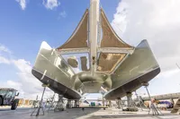 Catamaran Tag 60, 2018 model, on dry dock with clear sky background.