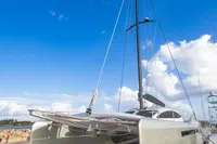 2018 Tag 60 catamaran on dry dock under a bright blue sky.