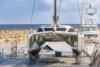 2018 Tag 60 catamaran docked at a marina with ocean backdrop.