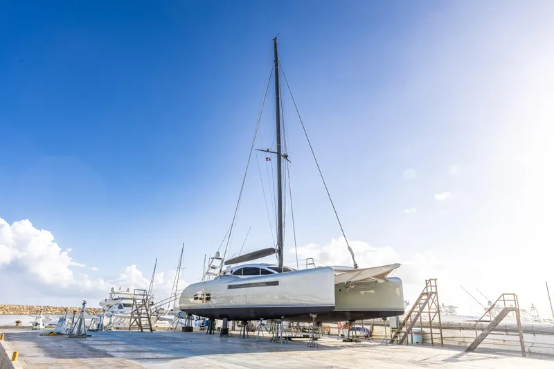 Yacht Photos Pics 2018 Tag 60 catamaran on dry dock under clear blue sky.